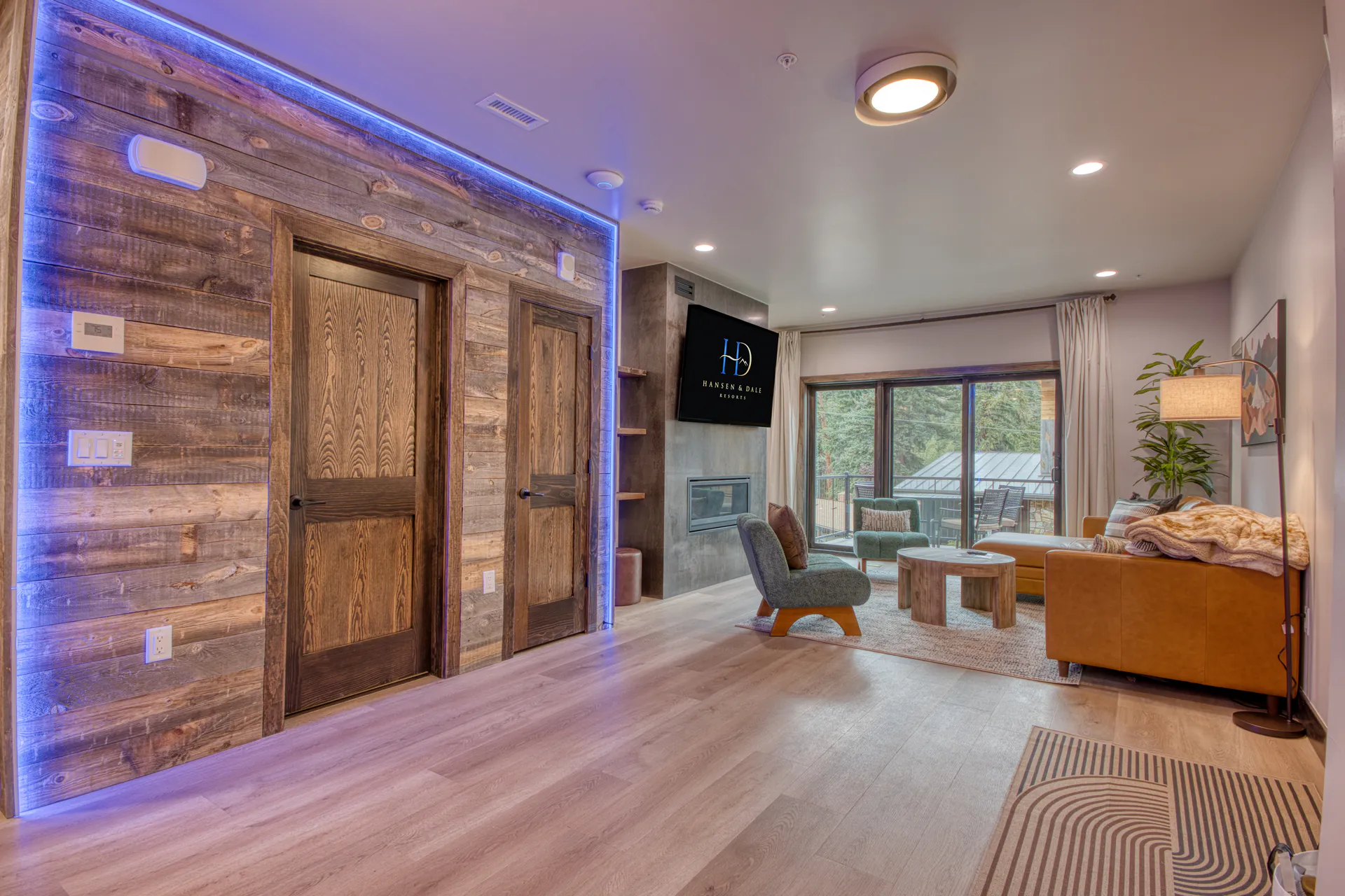 DreamView Hillside living room with fireplace and balcony access