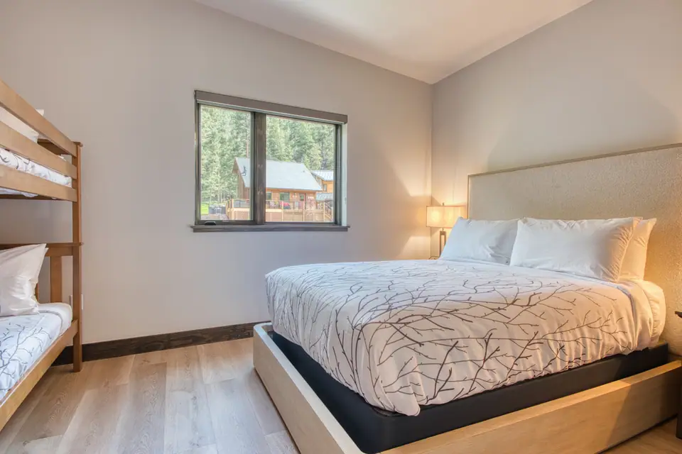 DreamView Suite bedroom with a queen bed and bunk beds